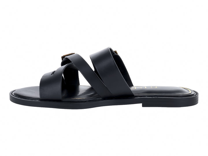 Sandalias planas negras con tiras y hebillas doradas de la marca GUESS.