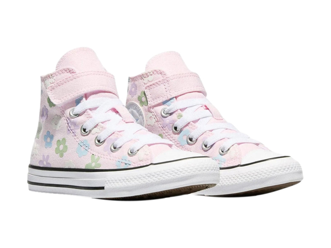Tenis Converse rosa para niña con estampado de flores coloridas y suela blanca.
