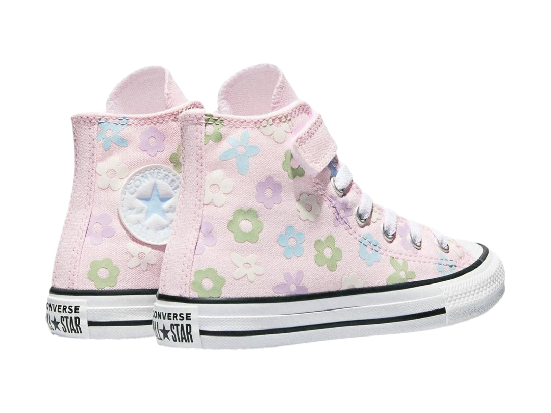 Tenis Converse rosa para niña con estampado de flores coloridas y suela blanca.
