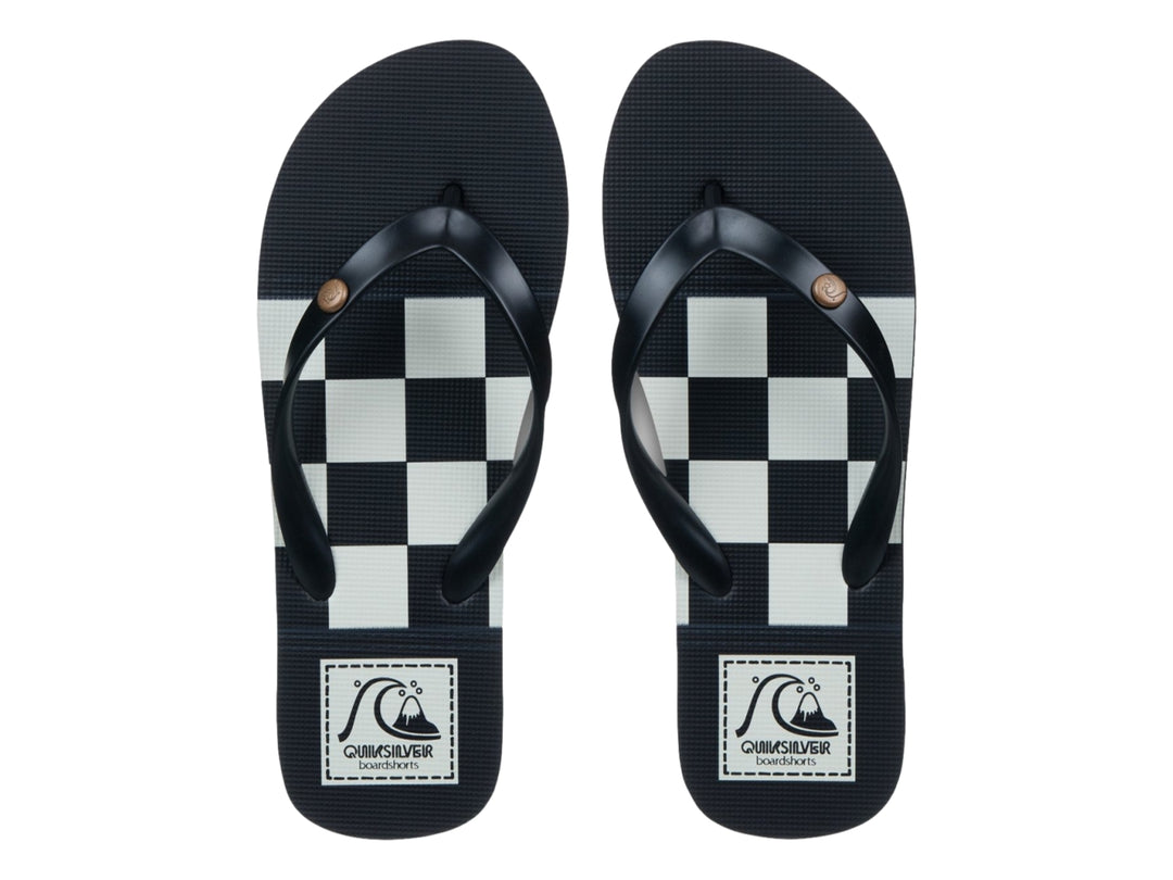 Sandalia Quiksilver Molokai Originals color negro con franja blanca en la suela, vista lateral.