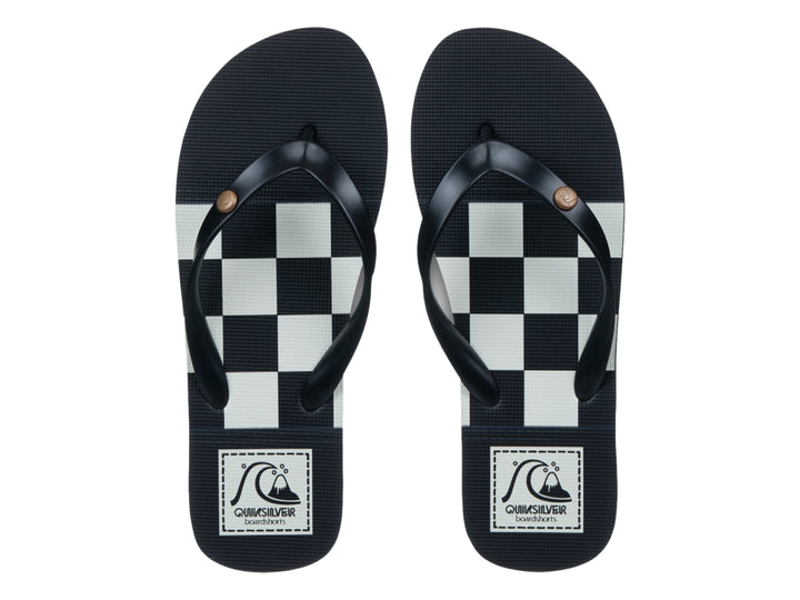 Sandalia Quiksilver Molokai Originals color negro con franja blanca en la suela, vista lateral.