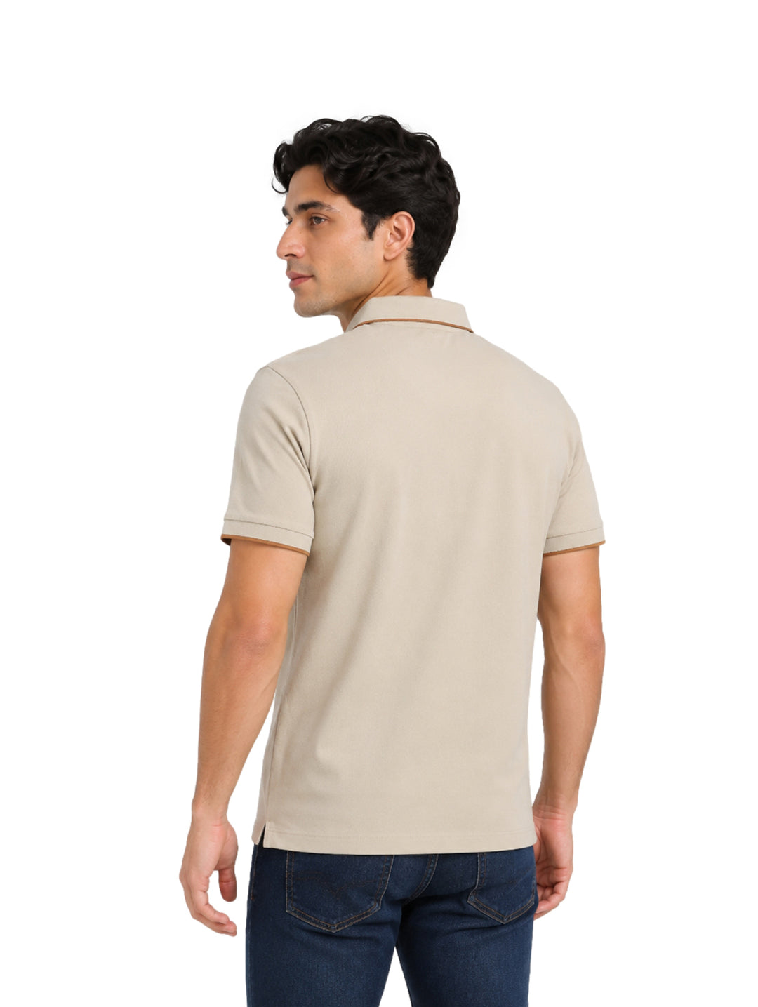 Hombre vistiendo playera polo color beige con detalles en marrón en el cuello y mangas.