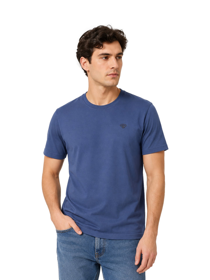 Hombre vistiendo una playera azul de manga corta y cuello redondo.