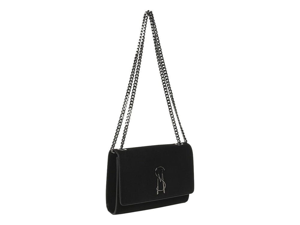 Bolso Steve Madden negro con solapa, logotipo metálico frontal y correa de cadena color gunmetal.