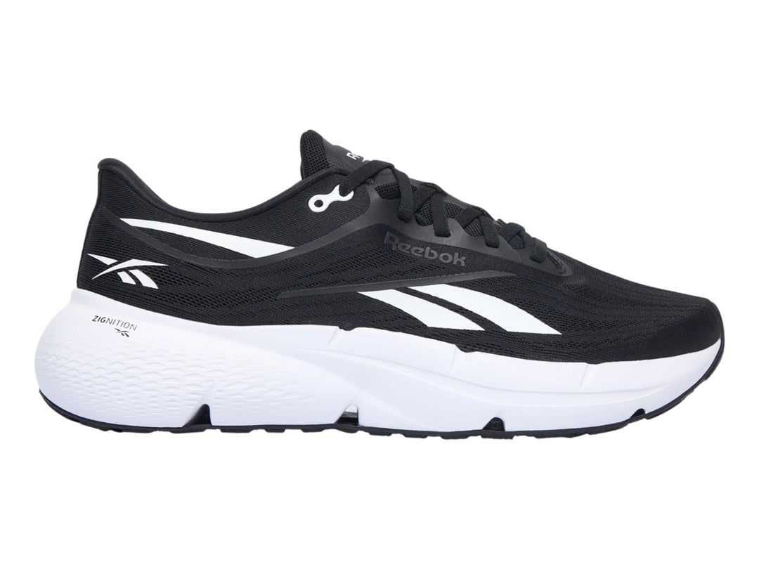 Tenis deportivos Reebok Zignition color negro con suela blanca y detalles laterales en blanco.