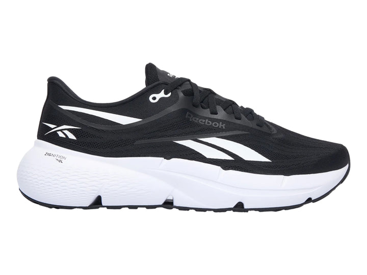 Tenis deportivos Reebok Zignition color negro con suela blanca y detalles laterales en blanco.