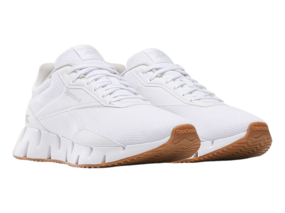 Tenis deportivos Reebok Zig Dynamica color blanco con suela café para mujer.