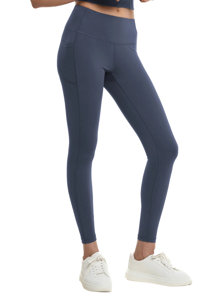 Mujer vistiendo leggings deportivos color azul marino de cintura alta.