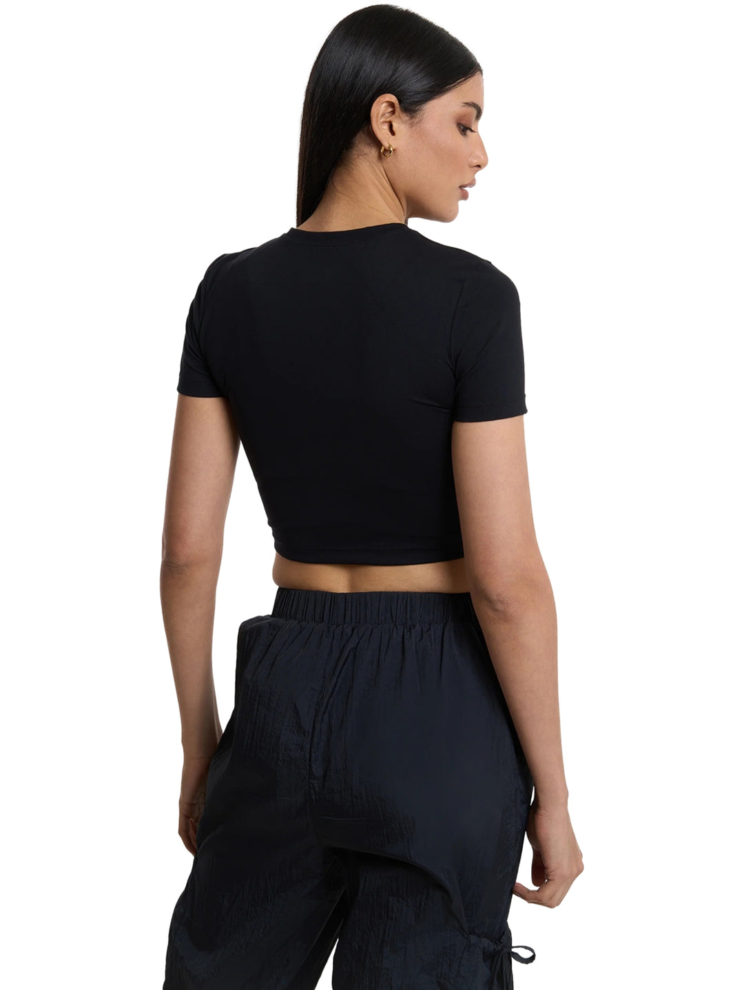 Mujer vistiendo playera deportiva crop top color negro de la marca Everlast.