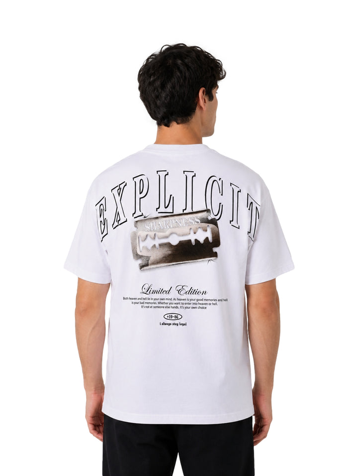 Hombre vistiendo una playera blanca de manga corta con estampados negros en el pecho.