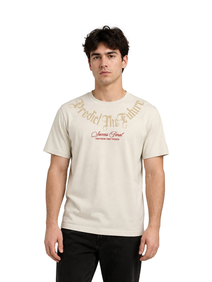 Hombre vistiendo playera color beige de manga corta con estampado frontal.