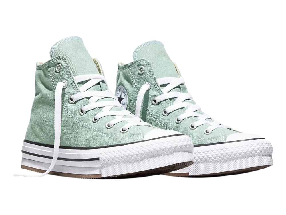 Tenis Converse de bota color verde con suela de plataforma blanca para niña.