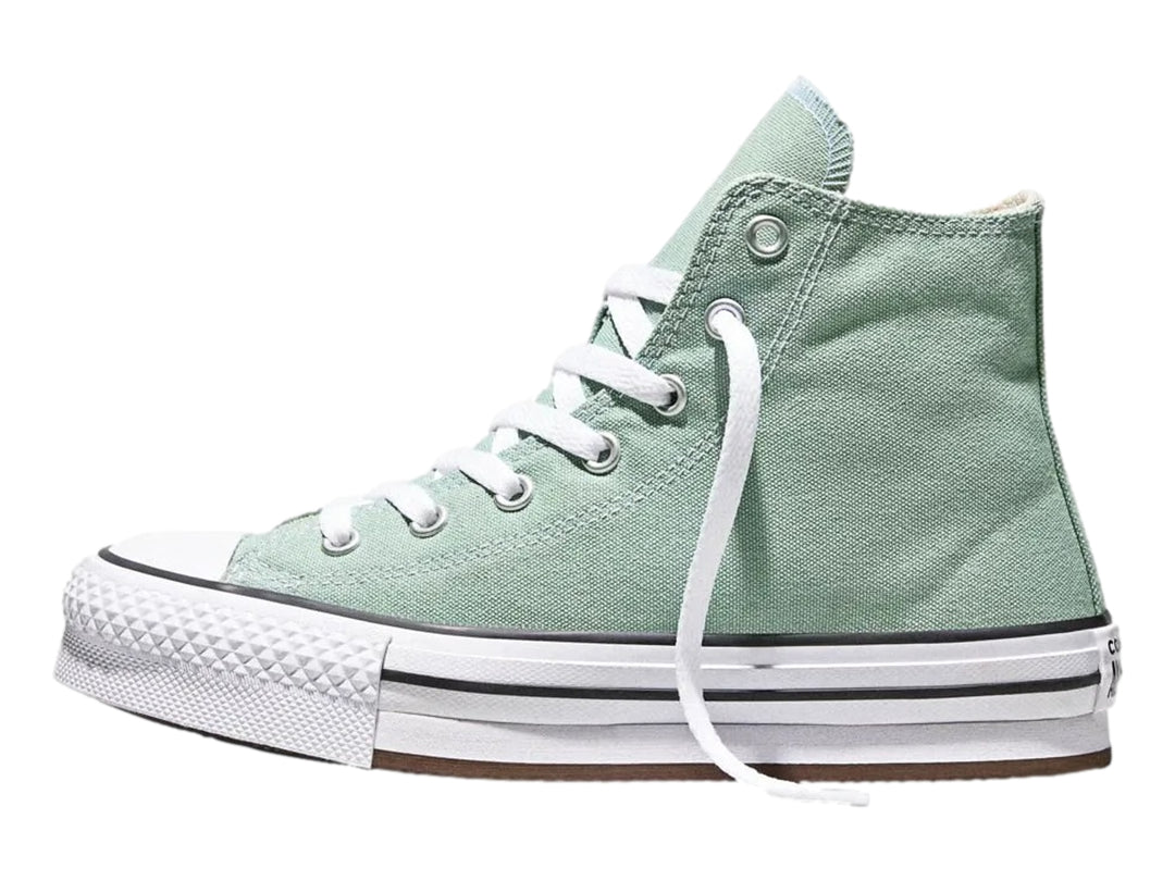 Tenis Converse de bota color verde con suela de plataforma blanca para niña.