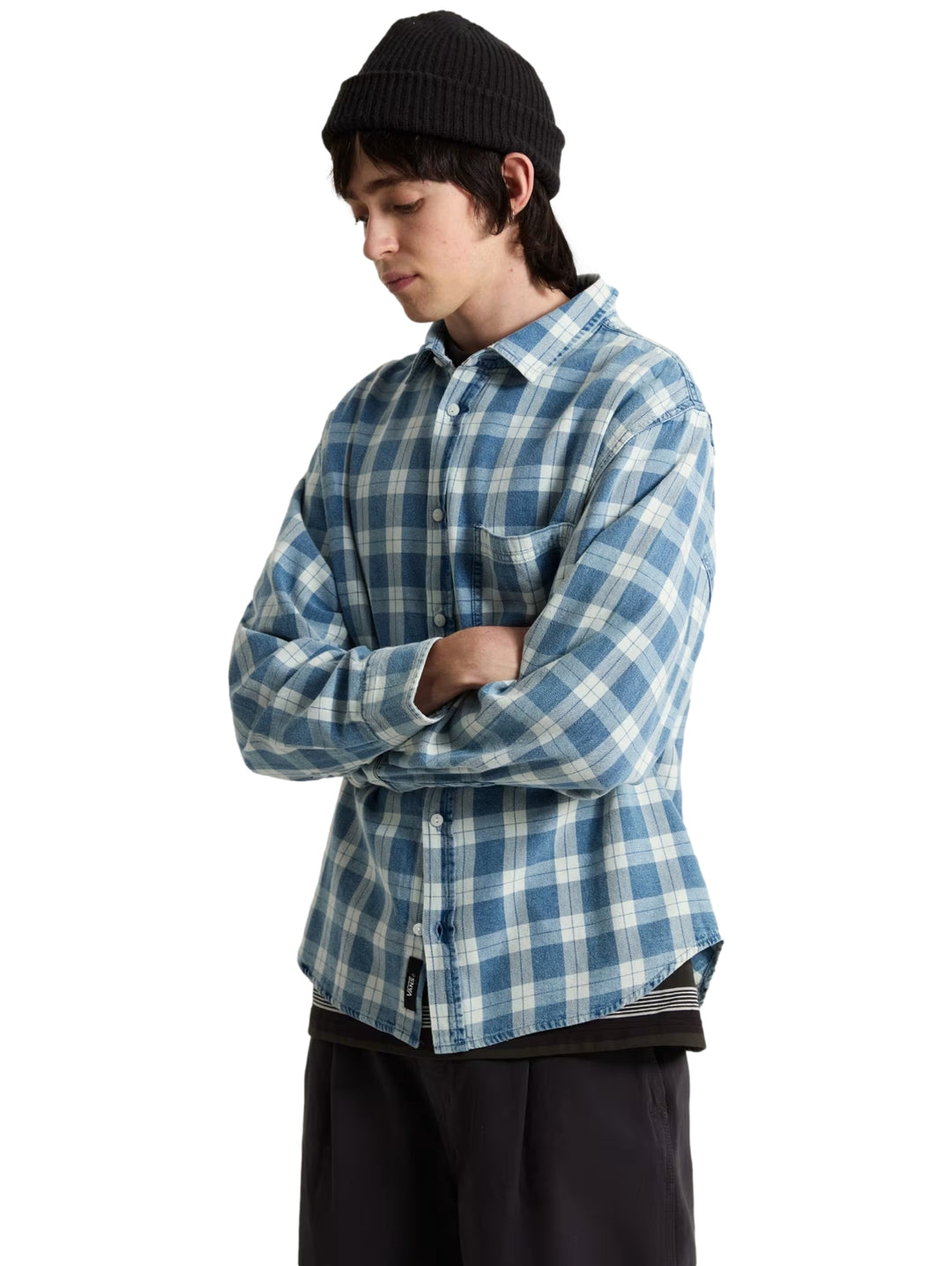 Hombre vistiendo una camisa VANS de manga larga con estampado de cuadros en color azul y blanco.