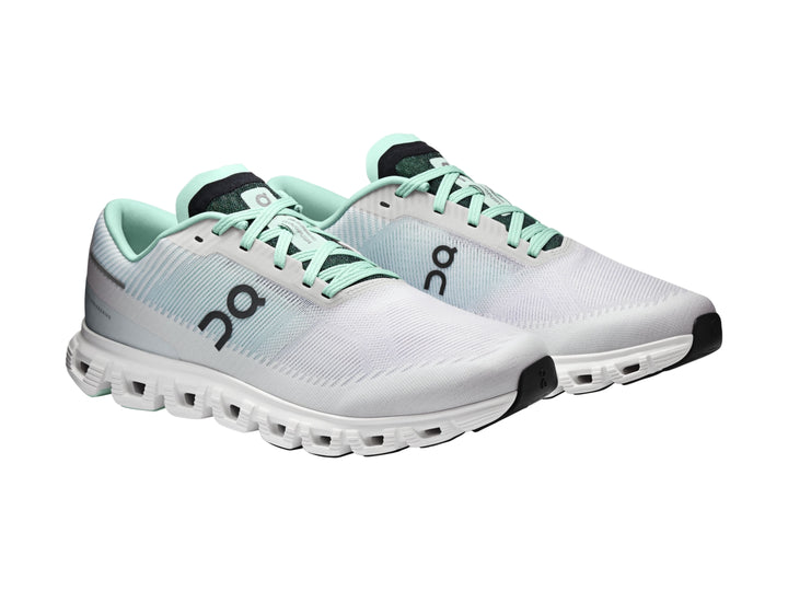 Tenis deportivos On Cloud 6 Push color blanco y azul claro con suela blanca y detalles negros.