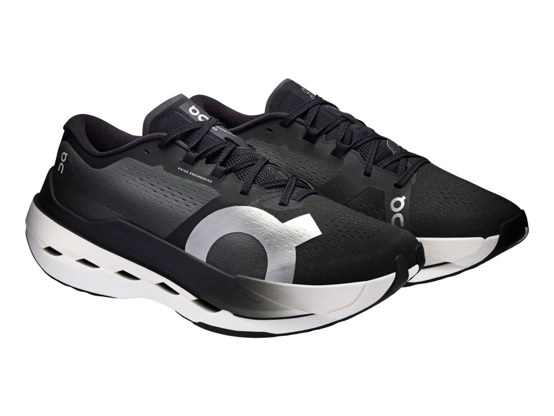 Tenis deportivos On Cloud Cloudboom Max color negro con suela blanca y detalles plateados.