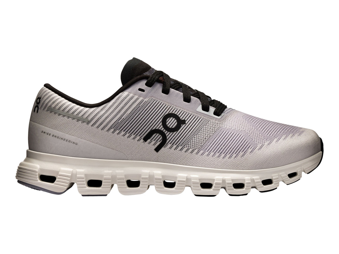 Tenis deportivos On Cloud color lila con suela blanca y detalles en negro para mujer.