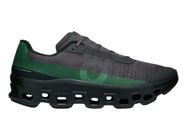 Tenis deportivos On Cloud Cloudmonster en color negro con un detalle lateral en color verde