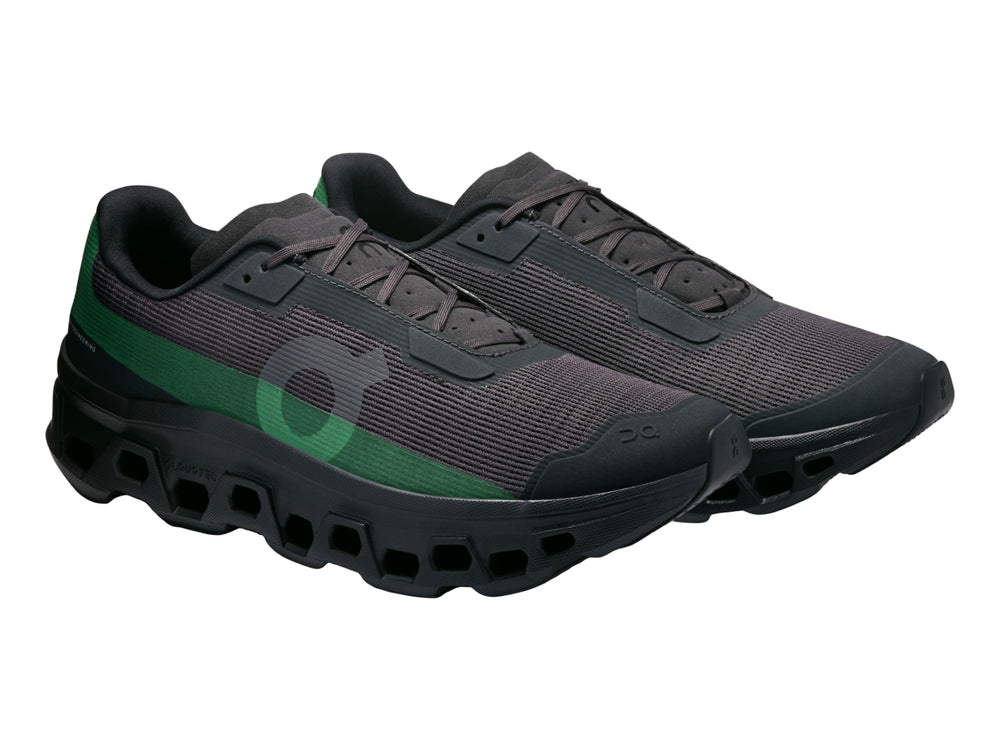 Tenis deportivos On Cloud Cloudmonster en color negro con un detalle lateral en color verde