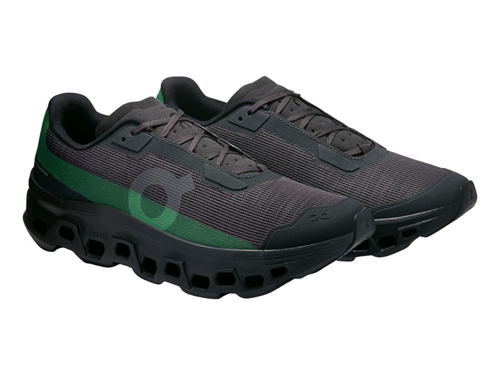 Tenis deportivos On Cloud Cloudmonster en color negro con un detalle lateral en color verde