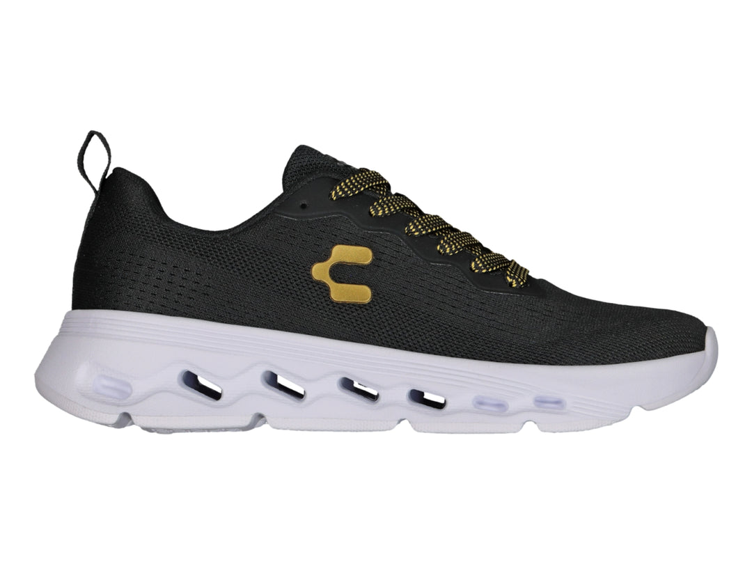 Tenis deportivos Charly color negro con suela blanca y detalles en dorado.