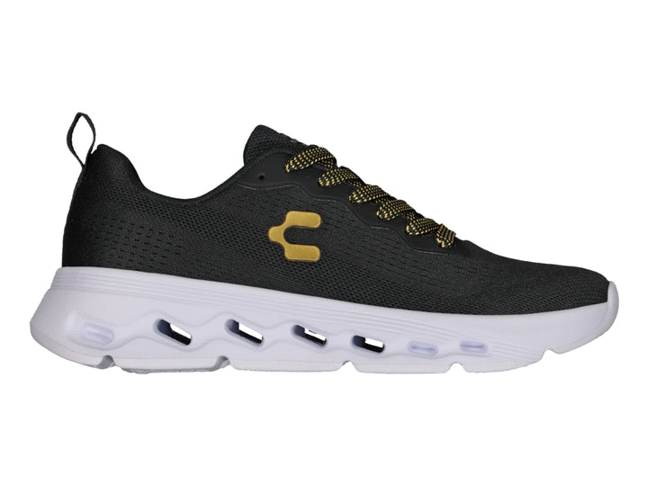 Tenis deportivos Charly color negro con suela blanca y detalles en dorado.