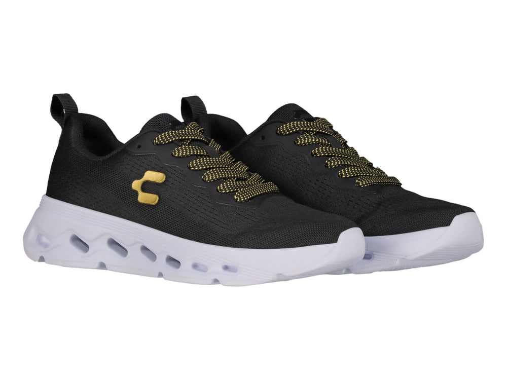 Tenis deportivos Charly color negro con suela blanca y detalles en dorado.