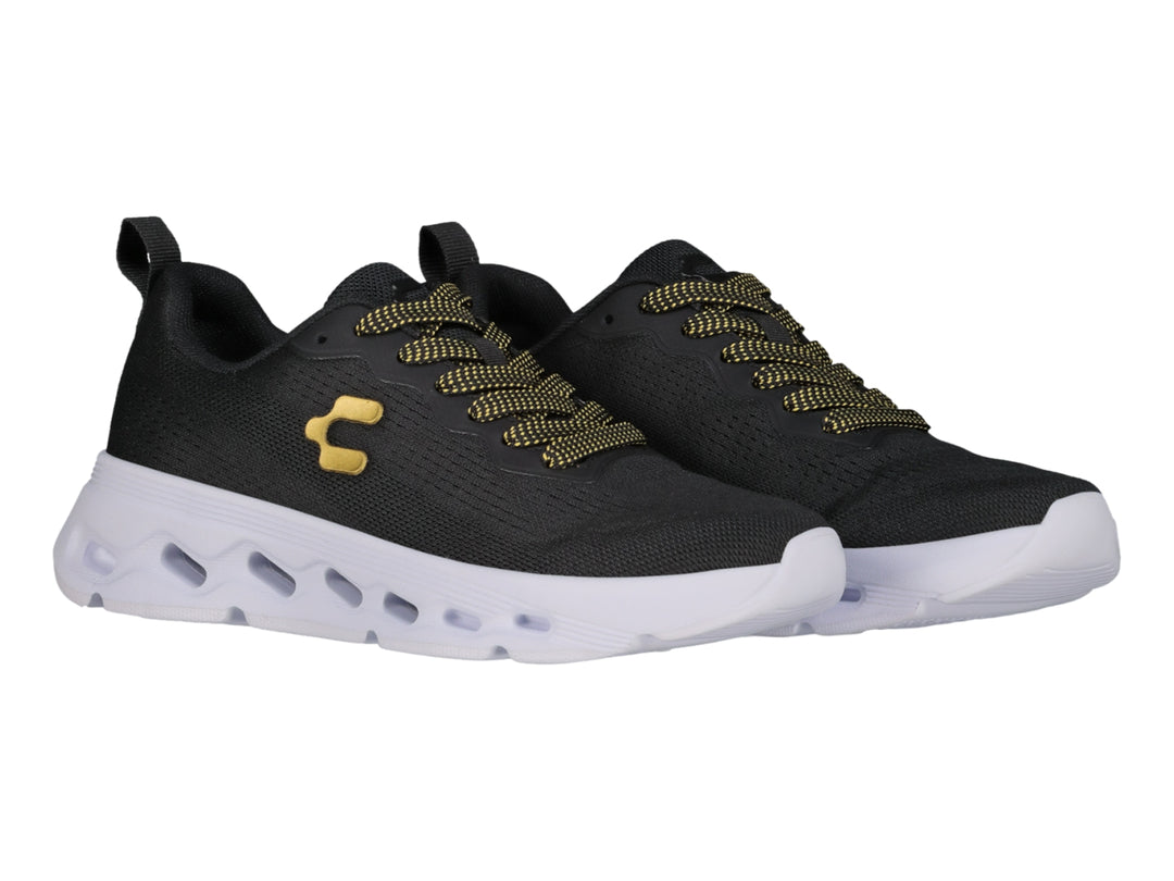 Tenis deportivos Charly color negro con suela blanca y detalles en dorado.