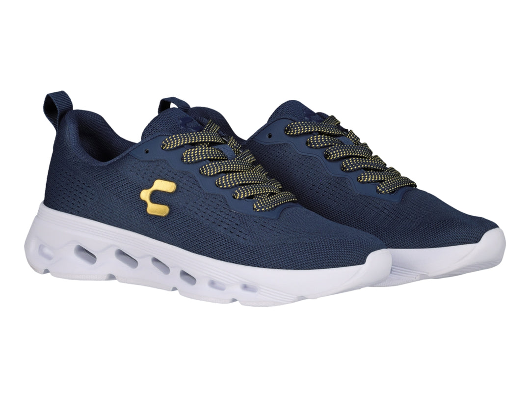 Tenis deportivos Charly color marino con suela blanca y detalles dorados.