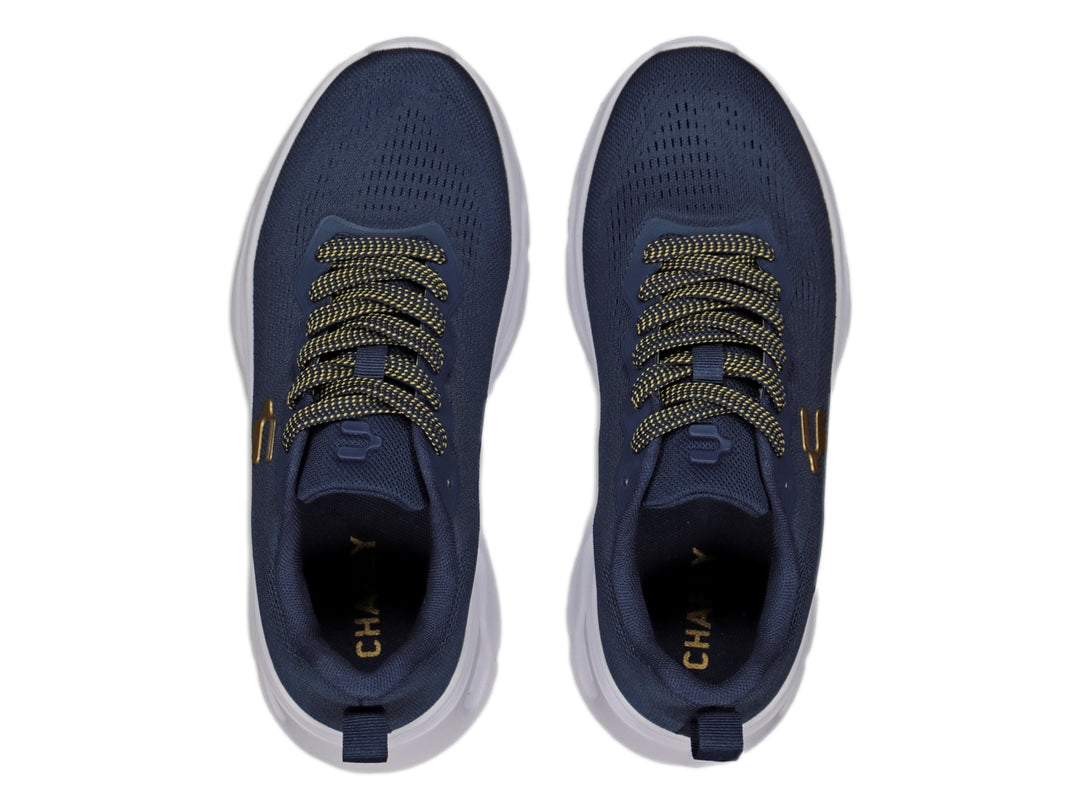 Tenis deportivos Charly color marino con suela blanca y detalles dorados.
