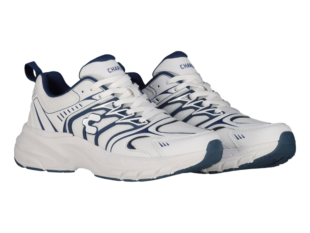 Tenis Charly Fashion Sport color blanco con detalles decorativos en azul marino y suela gruesa.