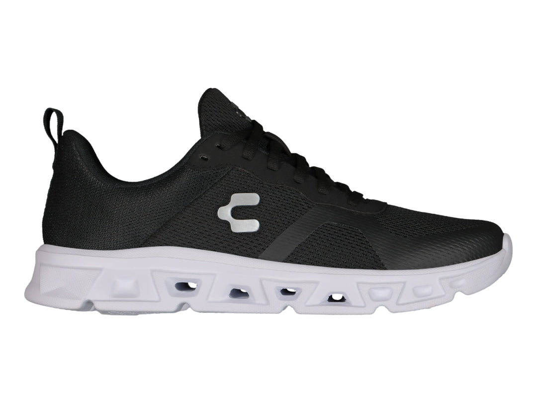 Tenis deportivos Charly color negro con suela blanca y tejido de malla.