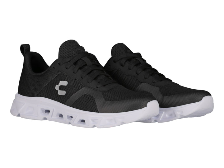 Tenis deportivos Charly color negro con suela blanca y tejido de malla.