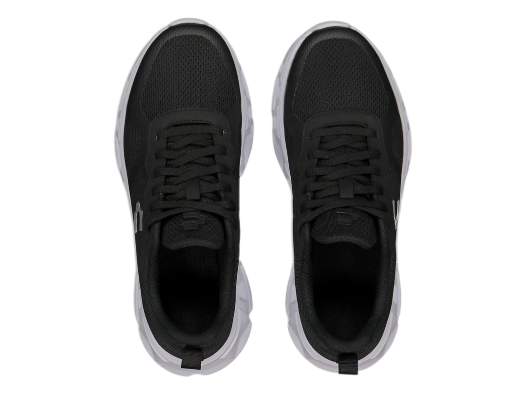 Tenis deportivos Charly color negro con suela blanca y tejido de malla.