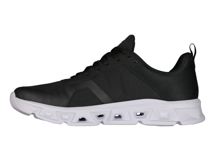Tenis deportivos Charly color negro con suela blanca y tejido de malla.