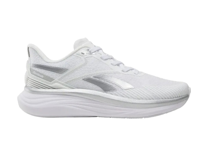 Tenis deportivos Reebok Viva Speed color blanco con detalles plateados, vista lateral.