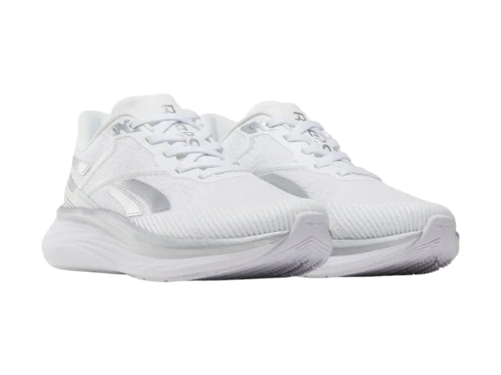 Tenis deportivos Reebok Viva Speed color blanco con detalles plateados, vista lateral.