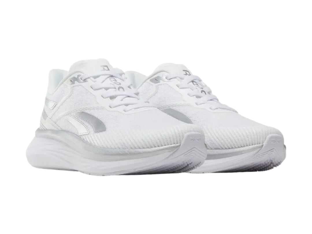 Tenis deportivos Reebok Viva Speed color blanco con detalles plateados, vista lateral.