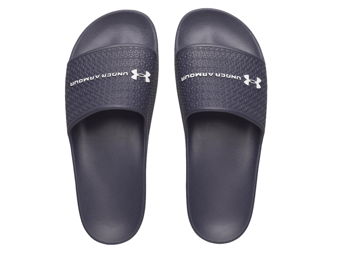 Sandalia Under Armour ARMR Slide Lite color azul oscuro con correa texturizada y logotipo blanco.