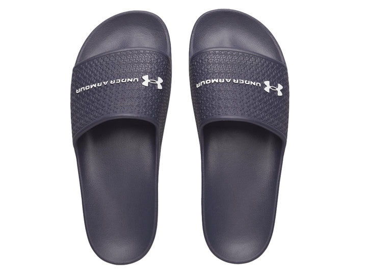 Sandalia Under Armour ARMR Slide Lite color azul oscuro con correa texturizada y logotipo blanco.
