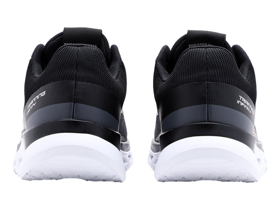 Tenis deportivos Pirma-Brasil color negro con suela blanca y tejido de malla.