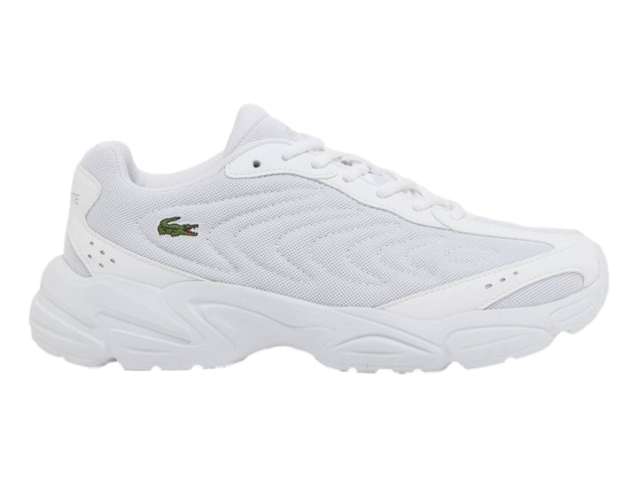 Tenis Lacoste Storm 96 2K Lite blancos para junior con suela gruesa y logo de cocodrilo verde.