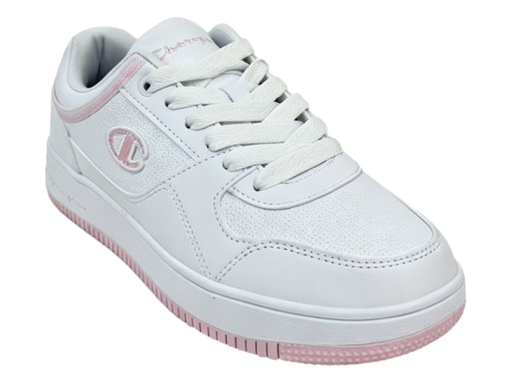 Tenis Champion blancos con detalles en color rosa en la suela y el cuello, diseño deportivo casual.