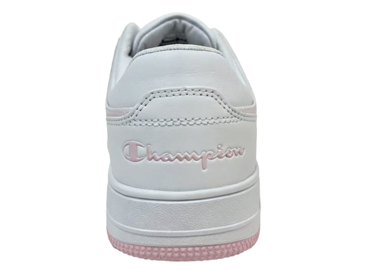 Tenis Champion blancos con detalles en color rosa en la suela y el cuello, diseño deportivo casual.
