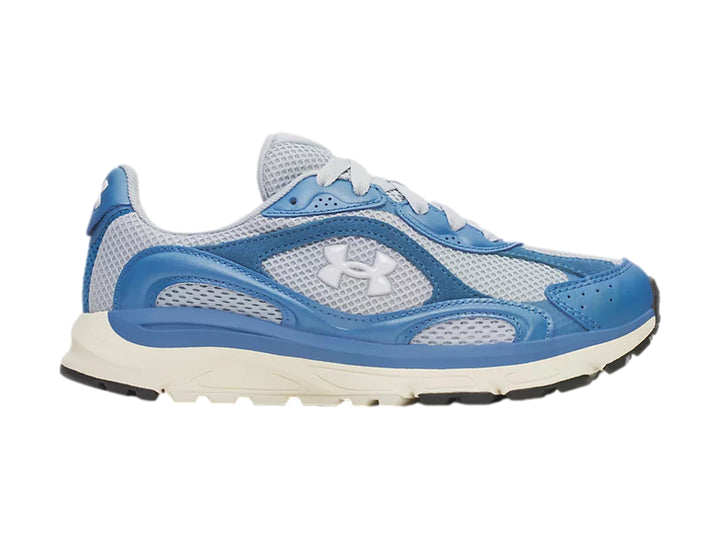 Tenis deportivos Under Armour en tonos azul y gris con suela blanca.