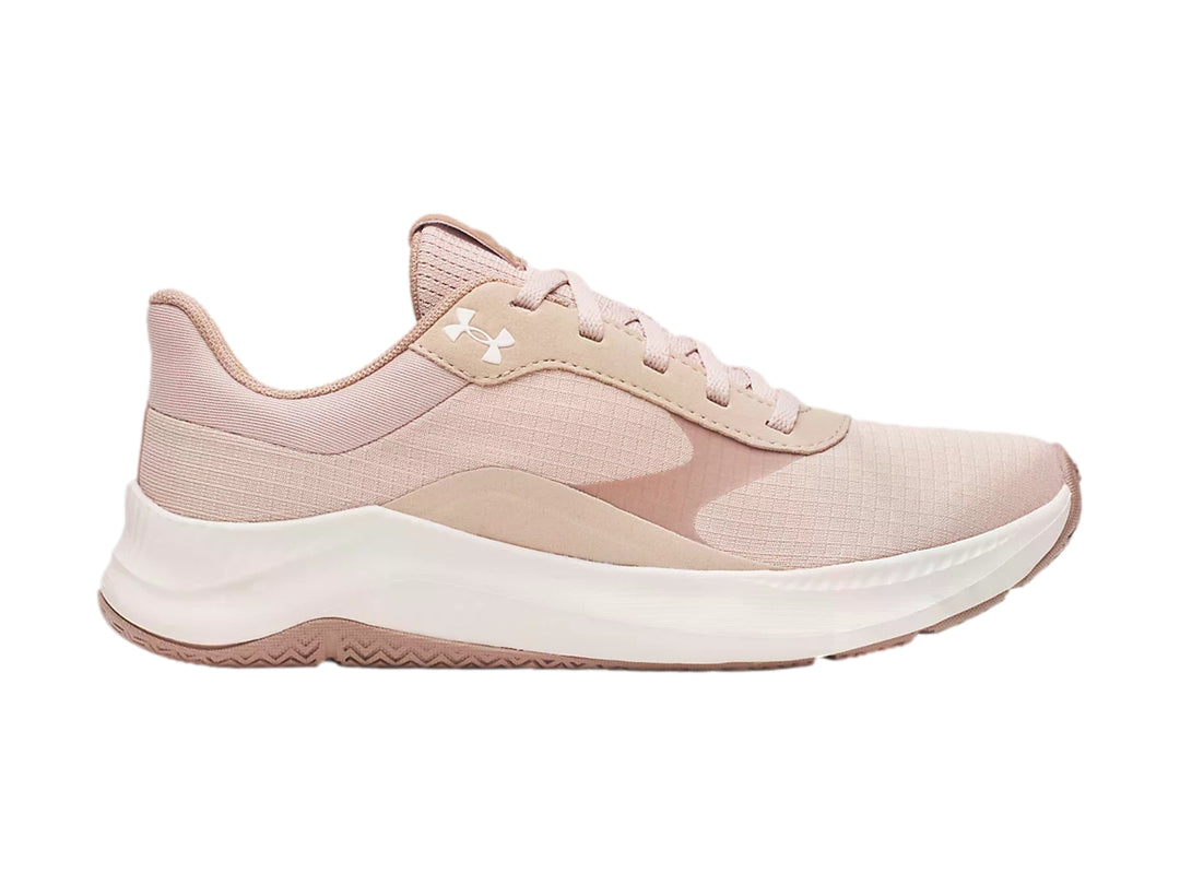 Tenis deportivos Under Armour en color rosa con suela blanca.
