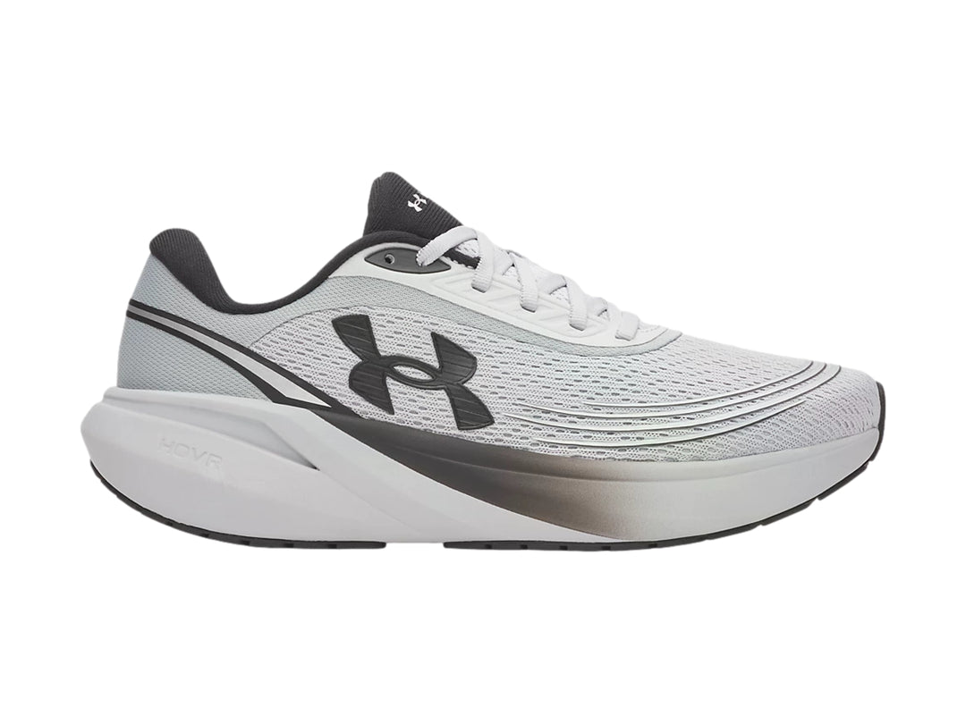 Tenis deportivos Under Armour color gris con detalles negros y suela blanca con degradado.