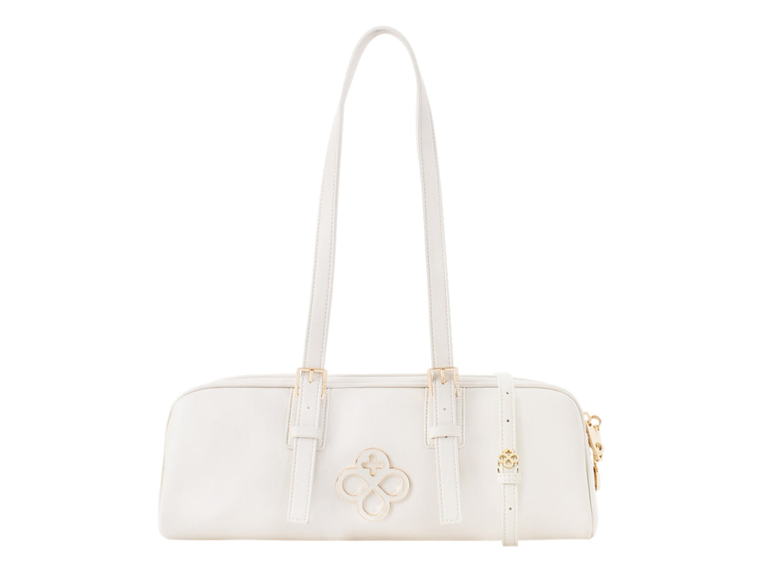 Bolsa de mano color beige de Jaime Ibiza con asas largas y detalles metálicos dorados.