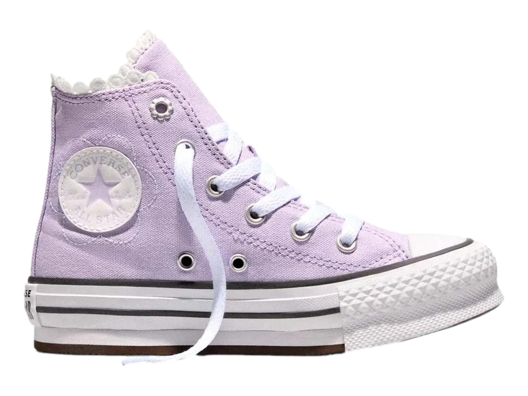 Tenis Converse de bota alta color lila con suela de plataforma blanca.