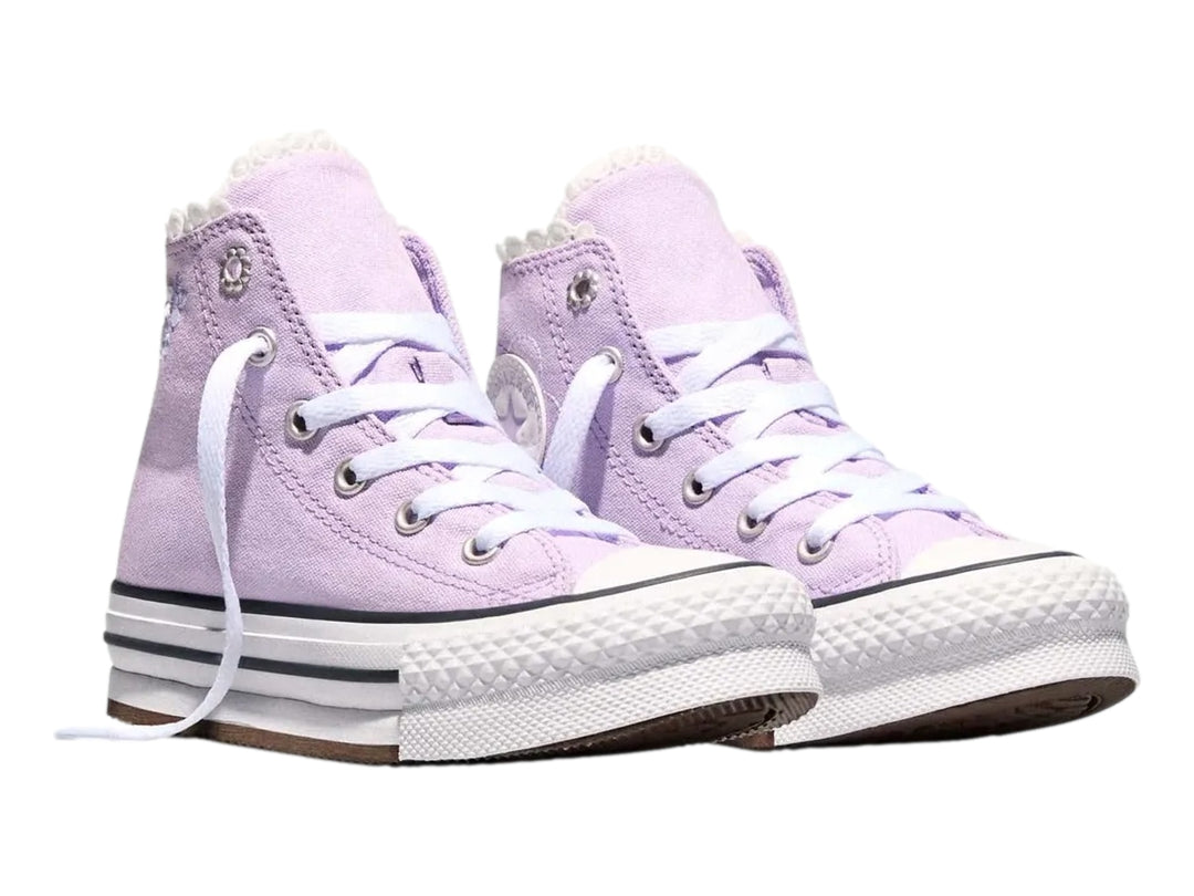 Tenis Converse de bota alta color lila con suela de plataforma blanca.